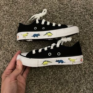 Converse Chuck Taylor black kid shoes with dinosaur footprints